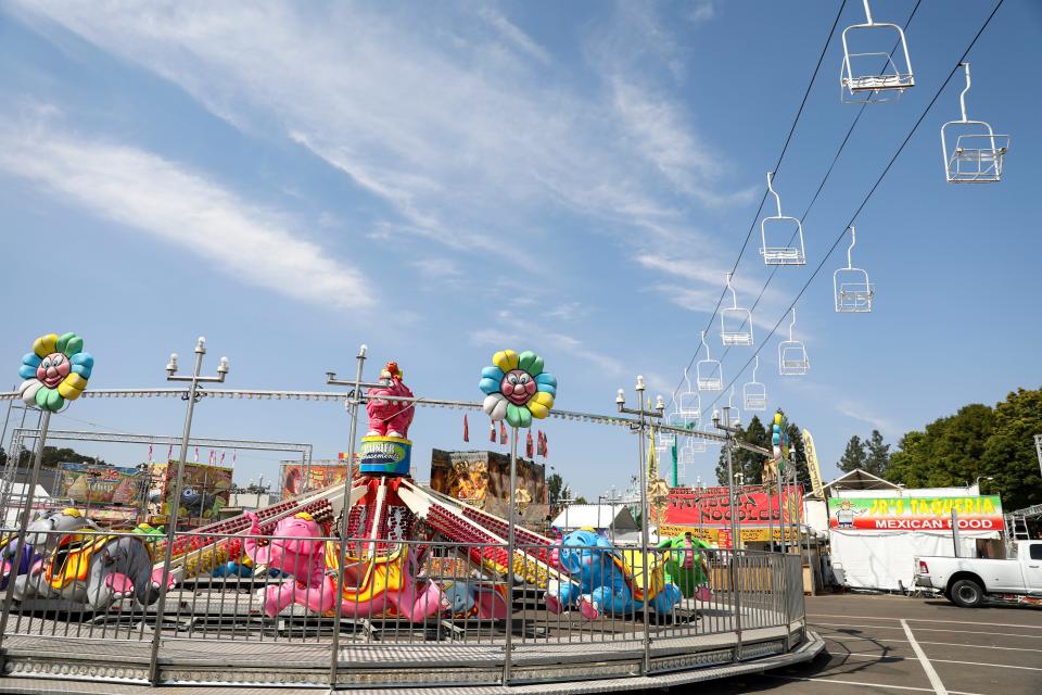 Crews work to set up Dumbo, one of the new rides this year at the Oregon State Fair. The fair opens at 10 a.m. Friday.