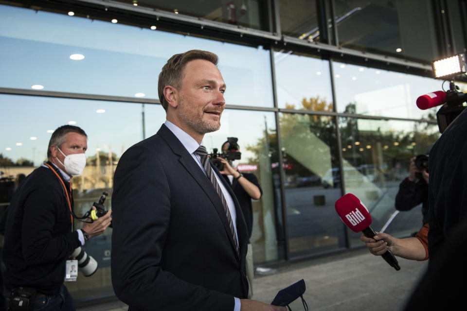 Christian Lindner, chairman of the German Liberal Party (FDP), leaves after talks with the SPD, FDP and Green party in Berlin, Thursday, Oct. 7, 2021. Germany's center-left Social Democrats and two smaller parties said Thursday they will deepen their talks next week on forming a new government, as the leader of outgoing Chancellor Angela Merkel's bloc indicated his willingness to step aside following its election defeat. (AP Photo/Steffi Loos)