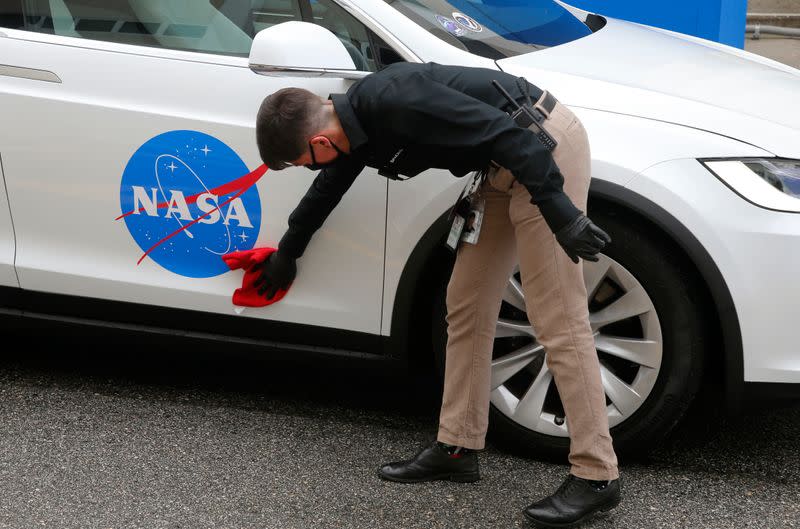 The crew car of the NASA astronauts is polished before the launch of a SpaceX Falcon 9 rocket and Crew Dragon spacecraft at the Kennedy Space Center, in Cape Canaveral