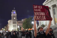 Protesters march, Thursday, Sept. 24, 2020, in Louisville, Ky. Authorities pleaded for calm while activists vowed to fight on Thursday in Kentucky's largest city, where a gunman wounded two police officers during anguished protests following the decision not to charge officers for killing Breonna Taylor. (AP Photo/John Minchillo)