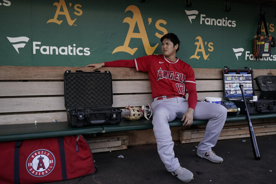 Los Angeles Angels' Shohei Ohtani sits in the dugout before the team's baseball game against the Oakland Athletics on Friday, Sept. 1, 2023, in Oakland, Calif. (AP Photo/Godofredo A. Vásquez)