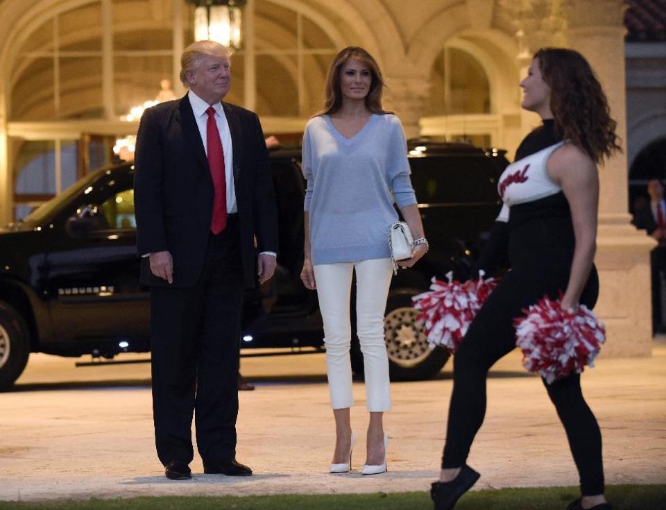 President Donald Trump and first lady Melania Trump watch the Palm Beach Central High School Band as they play for their arrival at Trump International Golf Club in West Palm Beach, Fla., Sunday, Feb. 5, 2017. The Trumps are attending a Super Bowl party at the club. (AP Photo/Susan Walsh)