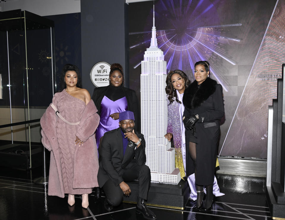 Taraji P. Henson, from left, Danielle Brooks, Blitz Bazawule, Oprah Winfrey and Fantasia Barrino from "The Color Purple" participate in the ceremonial lighting of the Empire State Building on Tuesday, Dec. 12, 2023, in New York. (Photo by Evan Agostini/Invision/AP)