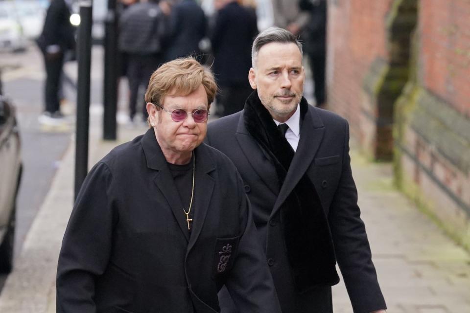 Sir Elton John and his partner David Furnish attended the funeral of Derek Draper (PA Wire)