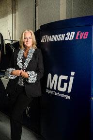 Christine Yardley, President, Print Panther Direct with her newly installed JETvarnish 3D Evolution Press.