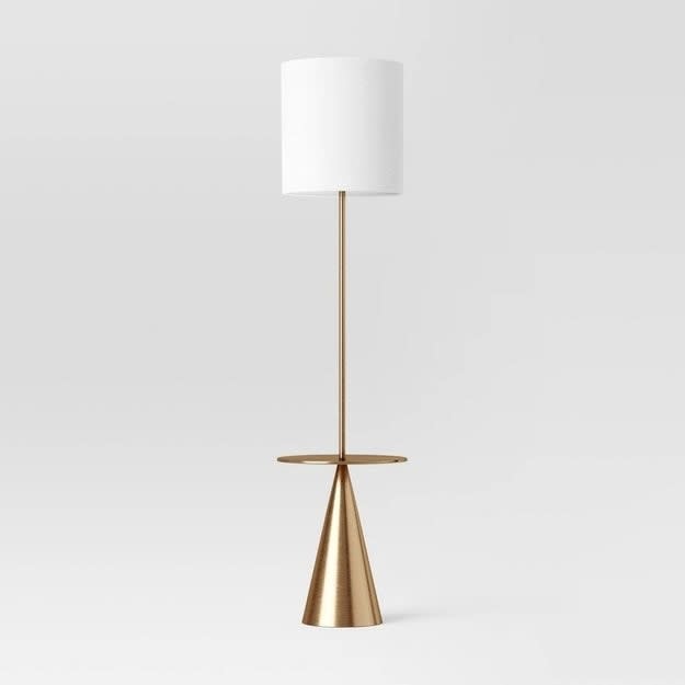 the floor lamp with a gold-tone triangle stand