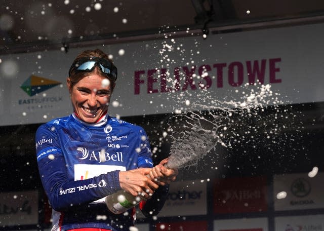 Demi Vollering celebrates on the podium after winning the Women’s Tour