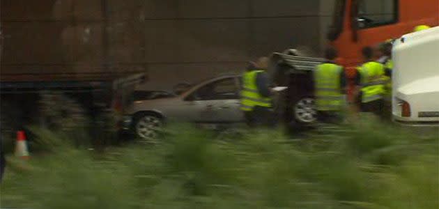 Driver escapes after car becomes wedged between two trucks in the Burnley Tunnel. Photo: 7News