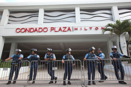 Police stand guard at the entrance of the Condado Plaza Hilton, at which the first seminar of the Puerto Rico Oversight, Management and Economic Stability Act (PROMESA) is scheduled to be held, in San Juan, August 31, 2016. REUTERS/Ana Martinez