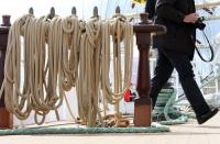 A visitor walks by rope tied to sails on board the German tall ship Alexander von Humboldt II.