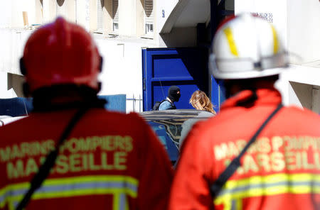 French firefighters secure the street as police conduct an investigation after two Frenchmen were arrested in Marseille, France, April 18, 2017 for planning to carry out an "imminent and violent attack" ahead of the first round of the presidential election on Sunday, France's interior minister said. REUTERS/Philippe Laurenson 