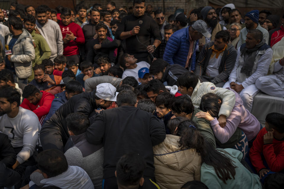 Indian wrestlers huddle together as they deliberate during against Wrestling Federation of India President Brijbhushan Sharan Singh and other officials in New Delhi, India, Thursday, Jan. 19, 2023. Top Indian wrestlers on Saturday called off a sit-in protest near the parliament building following a government assurance that a probe into their allegations of sexual harassments of young athletes by the federation would be completed in four weeks. (AP Photo/Altaf Qadri)