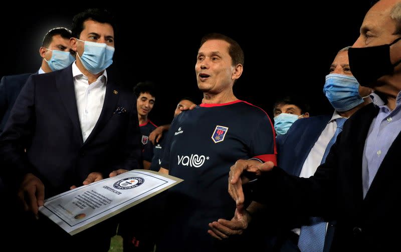 Ezzeldin Bahader, a 74-years-old Egyptian football player of 6th October Club talks with Dr. Ashraf Sobhi, Minister of Youth and Sports before a soccer match against El Ayat Sports Club at the Olympic Stadium in the Cairo suburb of Maadi