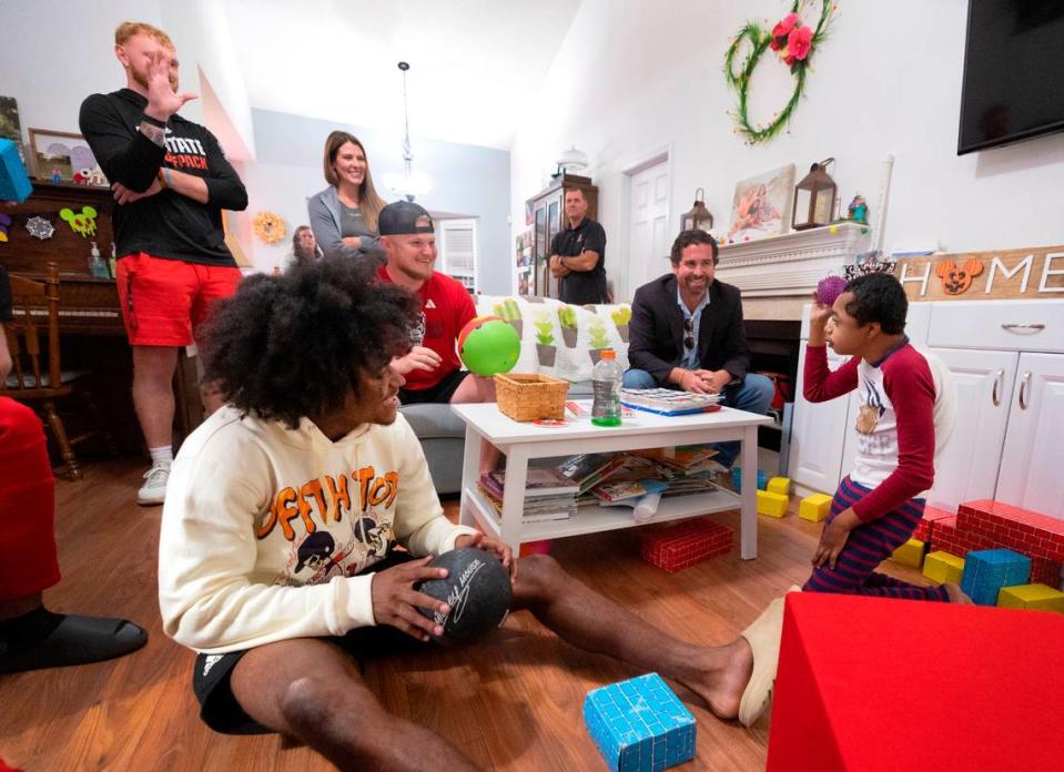 Grayson Ketchie plays ball with N.C. State football players including KC Concepcion, left, at Grayson’s home in Garner Wednesday, Oct. 18, 2023. Ketchie, 12, has been suffering from severe neurological issues since he was a baby. He has been a Wolfpack fan since he was three and the players made a surprise visit to his home that evening.