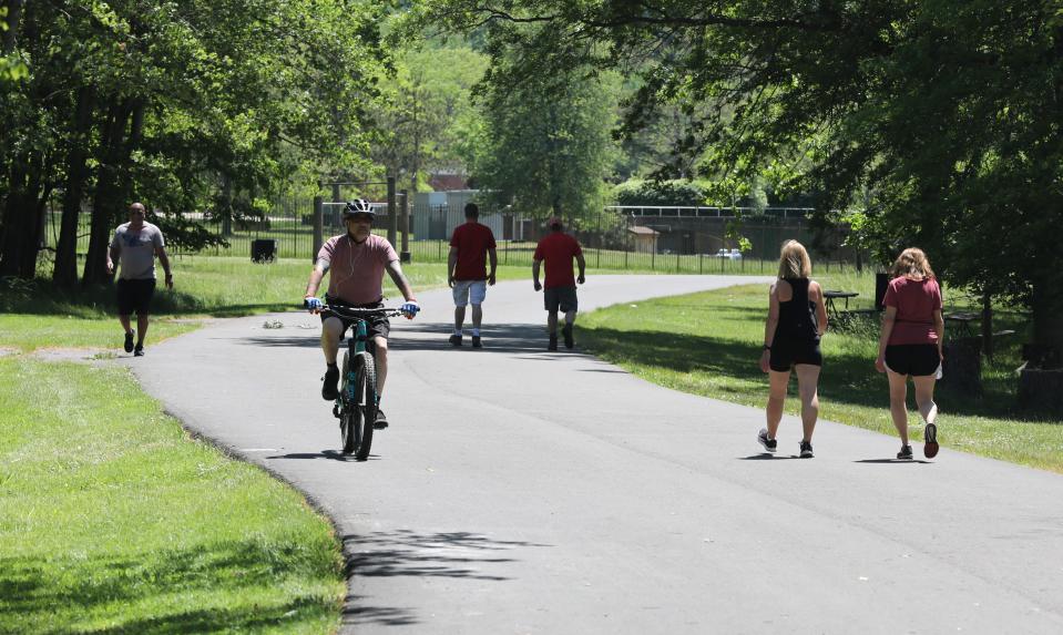 Walkers and bikers enjoy the trail around Rockland Lake State Park in Valley Cottage, May 27, 2021. 