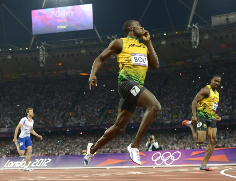 Usain Bolt (centre) crosses the finish line to win the men's 200m final at the 2012 London Olympics