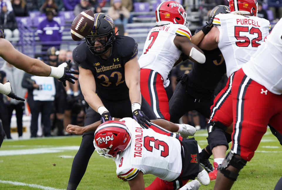 Oct 28, 2023; Evanston, Illinois, USA; Northwestern Wildcats linebacker Bryce Gallagher (32) forces a fumble by Maryland Terrapins quarterback <a class="link " href="https://sports.yahoo.com/ncaaf/players/299006" data-i13n="sec:content-canvas;subsec:anchor_text;elm:context_link" data-ylk="slk:Taulia Tagovailoa;sec:content-canvas;subsec:anchor_text;elm:context_link;itc:0">Taulia Tagovailoa</a> (3) during the first half at Ryan Field. Mandatory Credit: David Banks-USA TODAY Sports