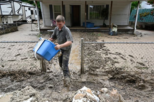 Members of the local Mennonite community remove mud-filled debris from homes following flooding at Ogden Hollar in Hindman, Kentucky, on July 30. (Photo: Timothy D. Easley/AP)