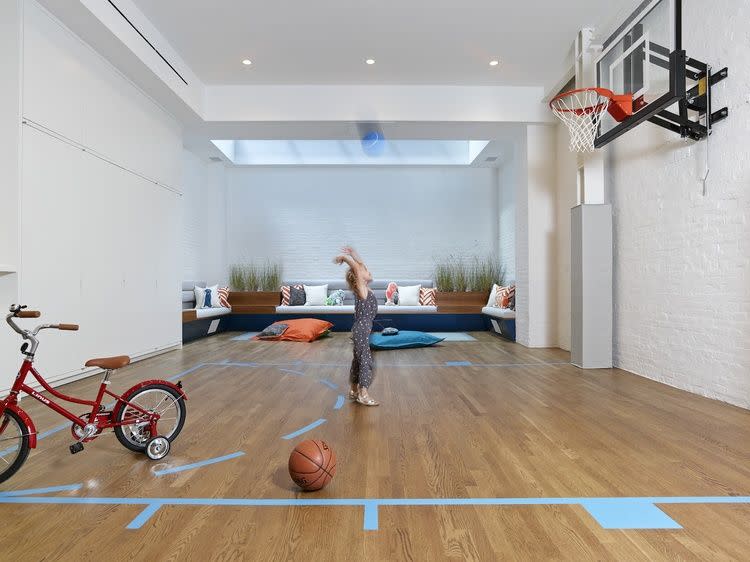 <p>Move over, Barclays Center. If you and/or your kids love shooting hoops, build a half court at home. You could also get a kid-sized, arcade-style basketball hoop if space is an issue. Studio DB had the right idea: We'll be in that little seating area in the back, if you need us. </p>