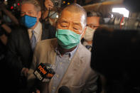 Hong Kong media tycoon and newspaper founder Jimmy Lai, center, walks out from a police station after being bailed out in Hong Kong, Wednesday, Aug. 12, 2020. The rounding up of the paper’s founder Jimmy Lai, the previous day and a raid on its headquarters have reinforced fears that a new national security law will be used to suppress dissent in Hong Kong after months of anti-government protests.(AP Photo/Kin Cheung)