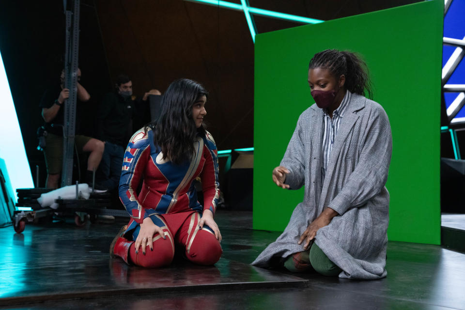 (L-R): Iman Vellani and Director Nia DaCosta on the set of Marvel Studios' THE MARVELS. Photo by Laura Radford. © 2023 MARVEL.