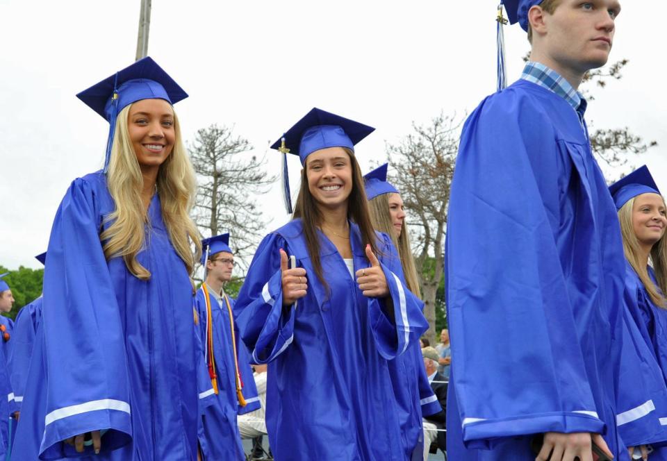 Victoria Vassalli, center, gives the thumbs up during the procession at Braintree High School graduation Saturday, June 4, 2022.