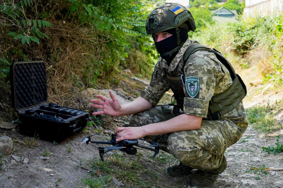 The serviceman, who identified himself by his call sign Santa, prepares to operate a commercial drone (AFP via Getty Images)