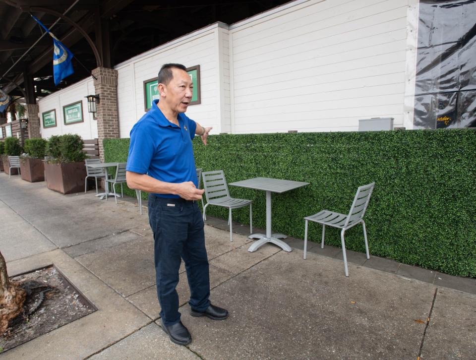 Owner Paul Nguyen gives a tour of the outdoor seating at new second location of his Eurasian Bistro at The Garden in downtown Pensacola on Thursday, Jan. 25, 2024. The restaurant will be opening soon.