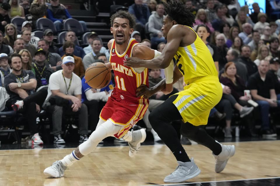 Atlanta Hawks guard Trae Young (11) drives as Utah Jazz guard Collin Sexton, right, defends during the first half of an NBA basketball game Friday, Feb. 3, 2023, in Salt Lake City. (AP Photo/Rick Bowmer)