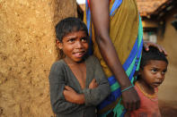 Children watch as health workers persuade elders to get vaccinated against the coronavirus at Jamsoti village, Uttar Pradesh state, India, on June 8, 2021. India's vaccination efforts are being undermined by widespread hesitancy and fear of the jabs, fueled by misinformation and mistrust. That's especially true in rural India, where two-thirds of the country’s nearly 1.4 billion people live. (AP Photo/Rajesh Kumar Singh)