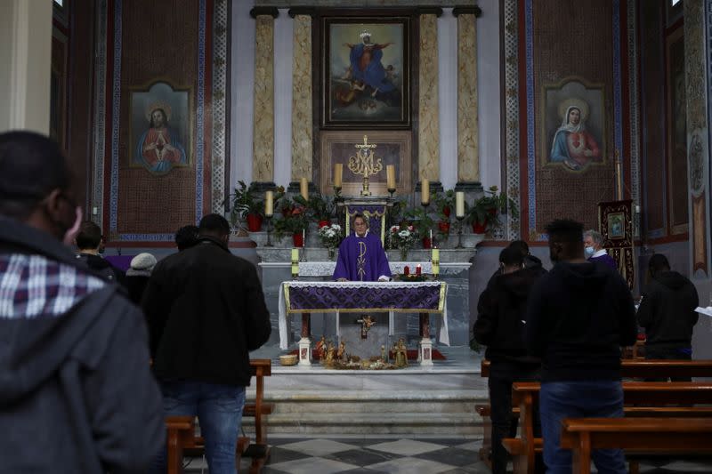 Refugees and migrants attend Holy Mass a day before the visit of Pope Francis on the island of Lesbos