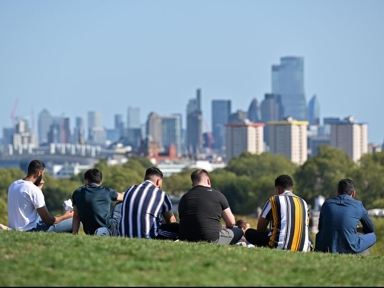 People gather on Primrose Hill on the last day before the new restrictions come into force (AFP via Getty Images)