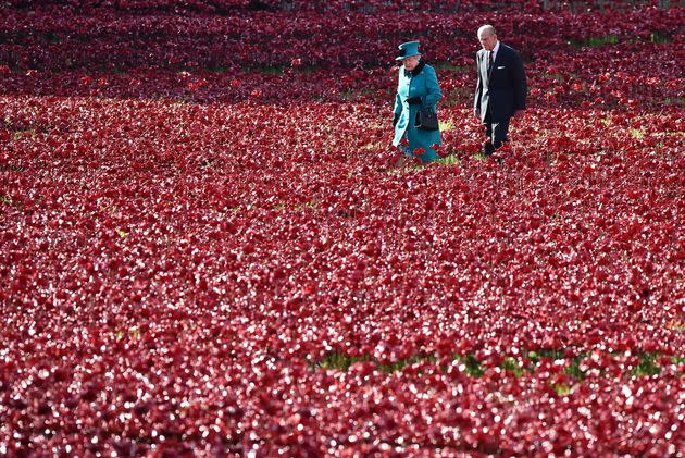 Queen Elizabeth II and husband Prince Philip, Duke of Edinburgh, visit the Tower of London's poppy installation on October 16, 2014. (Photo: Ben Stansall/AFP via Getty Images)