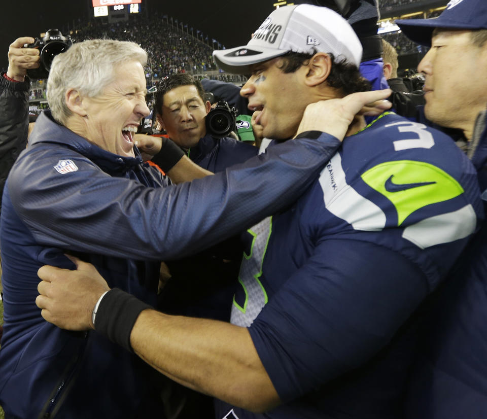 Seattle Seahawks head coach Pete Carroll celebrates with Seattle Seahawks' Russell Wilson after the second half of the NFL football NFC Championship game against the San Francisco 49ers Sunday, Jan. 19, 2014, in Seattle. The Seahawks won 23-17 to advance to Super Bowl XLVIII. (AP Photo/Ted S. Warren)