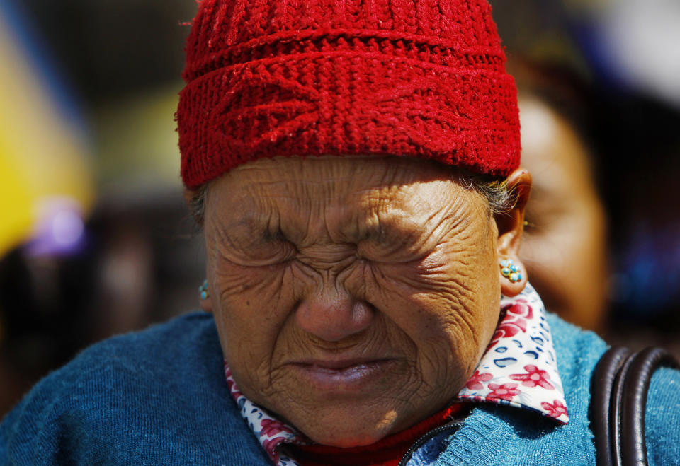 Mother of Nepalese mountaineer Ang Kaji Sherpa, killed in an avalanche on Mount Everest, cries while she waits for his body at Sherpa Monastery in Katmandu, Nepal, Saturday, April 19, 2014. Rescuers were searching through piles of snow and ice on the slopes of Mount Everest on Saturday for four Sherpa guides who were buried by an avalanche that killed 12 other Nepalese guides in the deadliest disaster on the world's highest peak. The Sherpa people are one of the main ethnic groups in Nepal's alpine region, and many make their living as climbing guides on Everest and other Himalayan peaks. (AP Photo/Niranjan Shrestha)