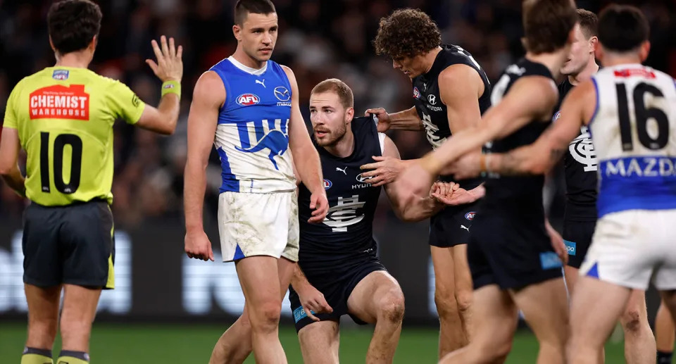 Seen here, Carlton's Harry McKay is helped to his feet after being crunched in a collision against North Melbourne. 