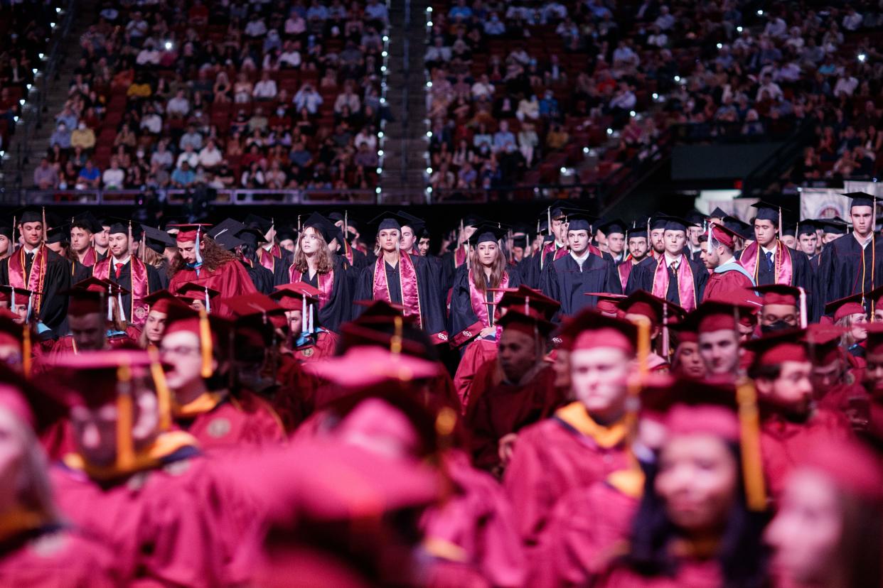 Florida State University graduates are recognized as they walk across the stage during a fall commencement ceremony.