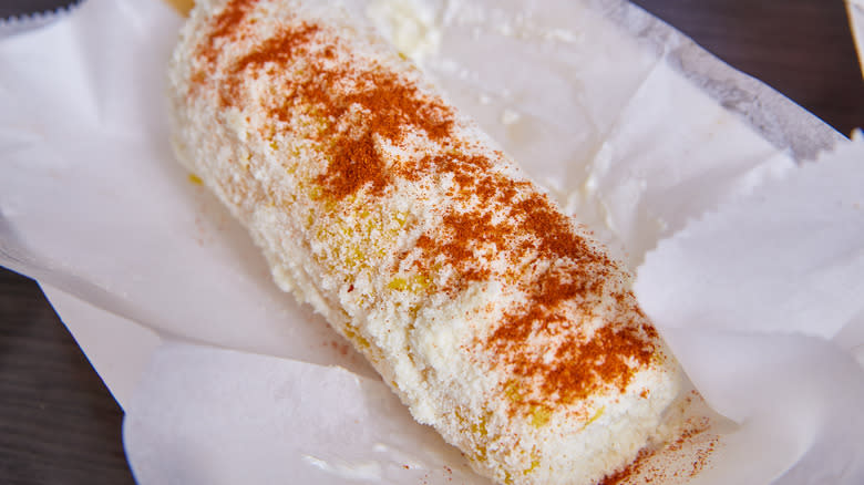 Stick of elote in wax paper