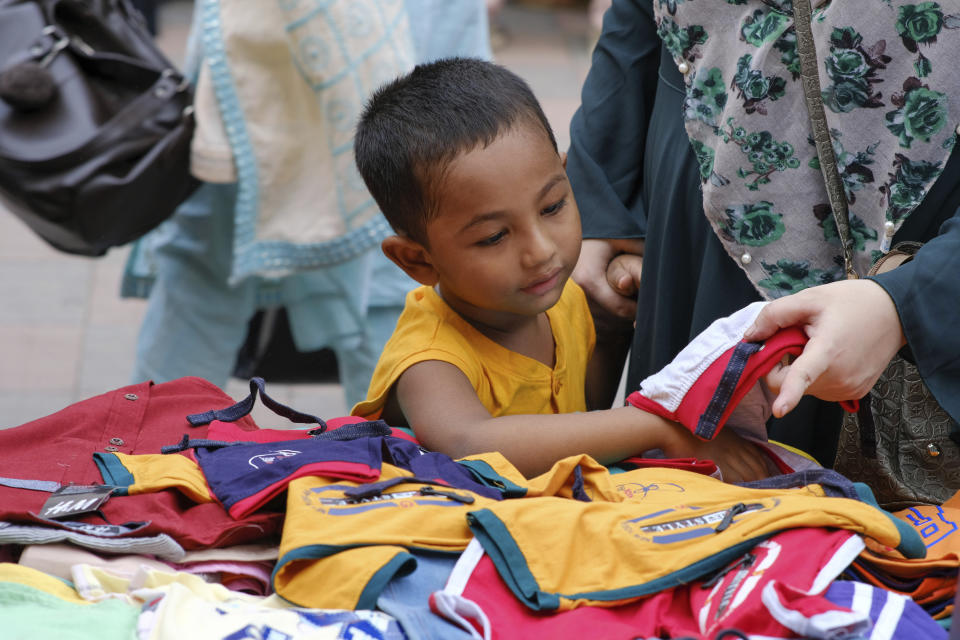 People shop at a market ahead of Eid-al Adha in Dhaka, Bangladesh, Friday, July 16, 2021. Millions of Bangladeshis are shopping and traveling during a controversial eight-day pause in the country’s strict coronavirus lockdown that the government is allowing for the Islamic festival Eid-al Adha. (AP Photo/Mahmud Hossain Opu)