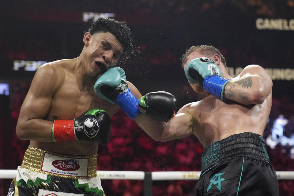 Canelo Alvarez hits Jaime Munguia in a super middleweight title fight Saturday, May 4, 2024, in Las Vegas. (AP Photo/John Locher)