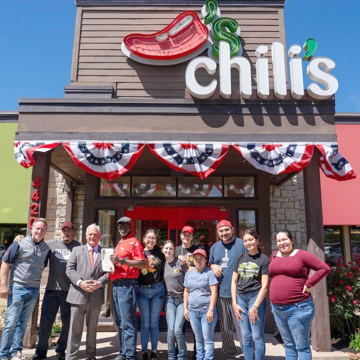 Austin Mayor Kirk P. Watson poses with employees of the Chili’s at 45th Street and North Lamar Boulevard in Austin as part of his proclamation of April 5, 2024 “Chili’s at 45th and Lamar Day.” (Courtesy of the Office of Mayor Kirk Watson)