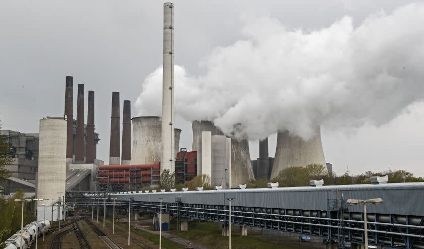 A coal-fired RWE power plant steams on a sunny day in Neurath, Germany, Thursday, April 29, 2021. Germany's top court ruled Thursday that the country's government has to set clear goals for reducing greenhouse gas emissions after 2030, arguing that current legislation doesn't go far enough in ensuring that climate change is limited to acceptable levels. (AP Photo/Martin Meissner)