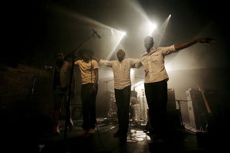 Malian band Songhoy Blues members, Nathanael Dembele (L-R), Garba Toure, Aliou Toure and Oumar Toure, react at the end of their concert at Village Underground in London, Britain, May 28, 2015. REUTERS/Simon Newman