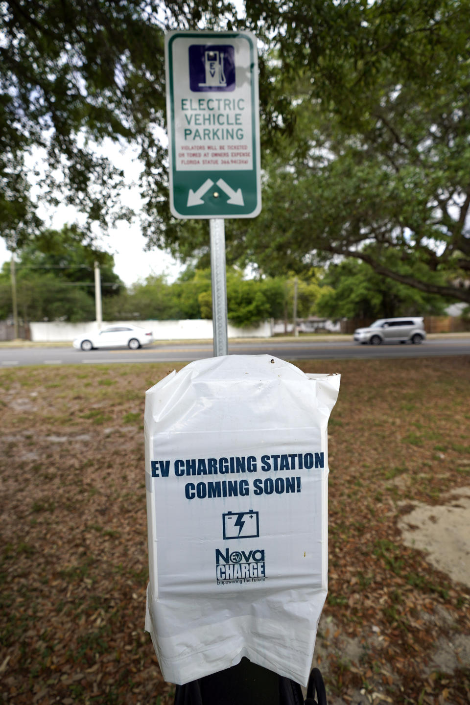 A parking area with charging stations for electric vehicles at a public park is seen Thursday, April 1, 2021, in Orlando, Fla. As part of an infrastructure proposal by the Biden administration, $174 billion will be set aside to build 500,000 electric vehicle charging stations, electrify 20% of school buses and electrify the federal fleet, including U.S. Postal Service vehicles.(AP Photo/John Raoux)