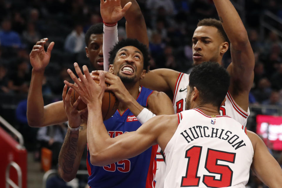 Detroit Pistons forward Christian Wood (35) is pressured by Chicago Bulls forwards Thaddeus Young, left, Daniel Gafford, back right, and forward Chandler Hutchison (15) during the first half of an NBA basketball game, Saturday, Jan. 11, 2020, in Detroit. (AP Photo/Carlos Osorio)