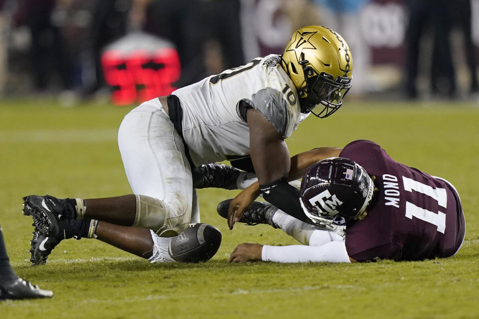 Texas A&M quarterback Kellen Mond (11) fumbles the ball on fourth down as he is hit by Vanderbilt's Dayo Odeyingbo (10) during the second half of an NCAA college football game Saturday, Sept. 26, 2020, in College Station, Texas. Texas A&M won 17-12. (AP Photo/David J. Phillip)