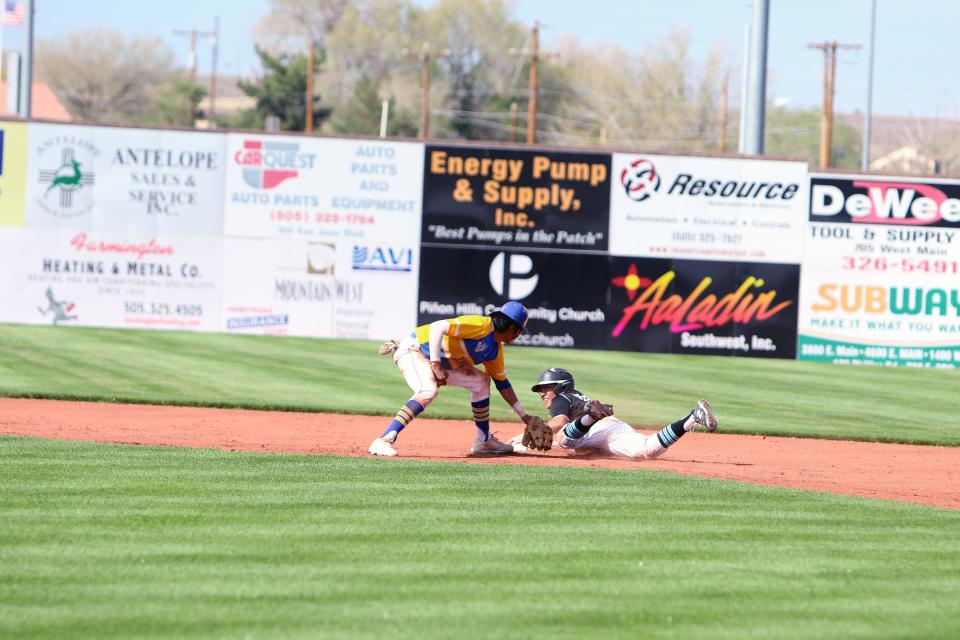 Navajo Prep's Daniel Yazzie safely slides into second base on a stolen base ahead of a tag by Zuni's Nathan Sanchez during the bottom of the first inning of a game, Thursday, April 28, 2022 at Ricketts Park.