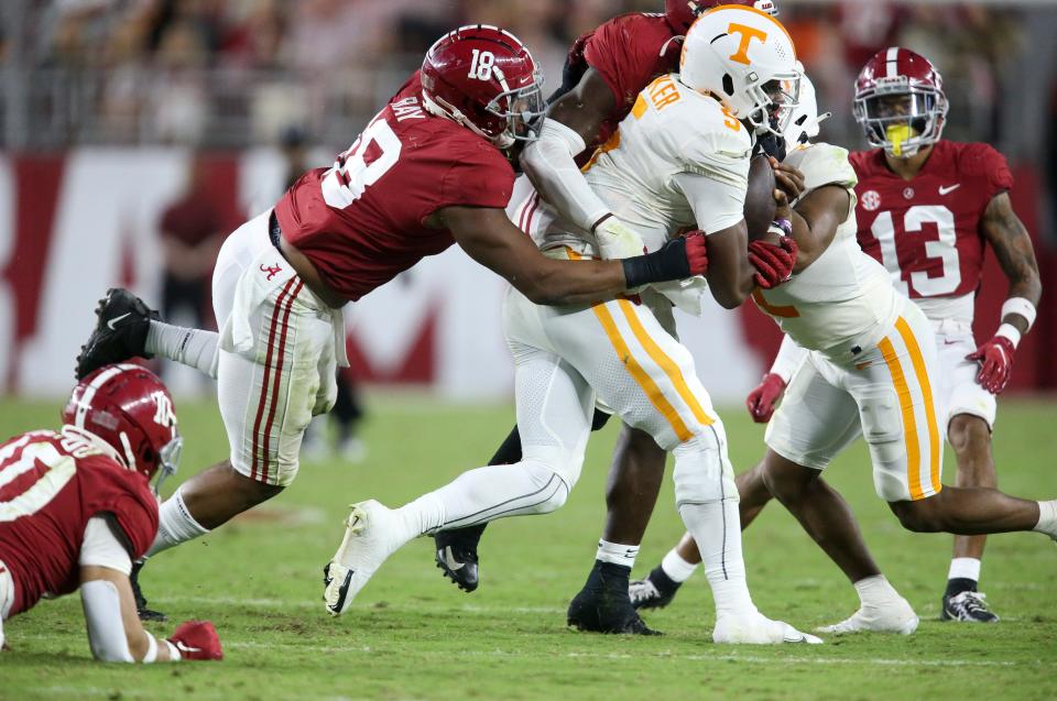 Oct 23, 2021; Tuscaloosa, Alabama, USA; Alabama defensive lineman LaBryan Ray (18) and several Crimson Tide defenders combine to tackle Tennessee quarterback Hendon Hooker (5) at Bryant-Denny Stadium. Alabama defeated Tennessee 52-24. Mandatory Credit: Gary Cosby Jr.-USA TODAY Sports