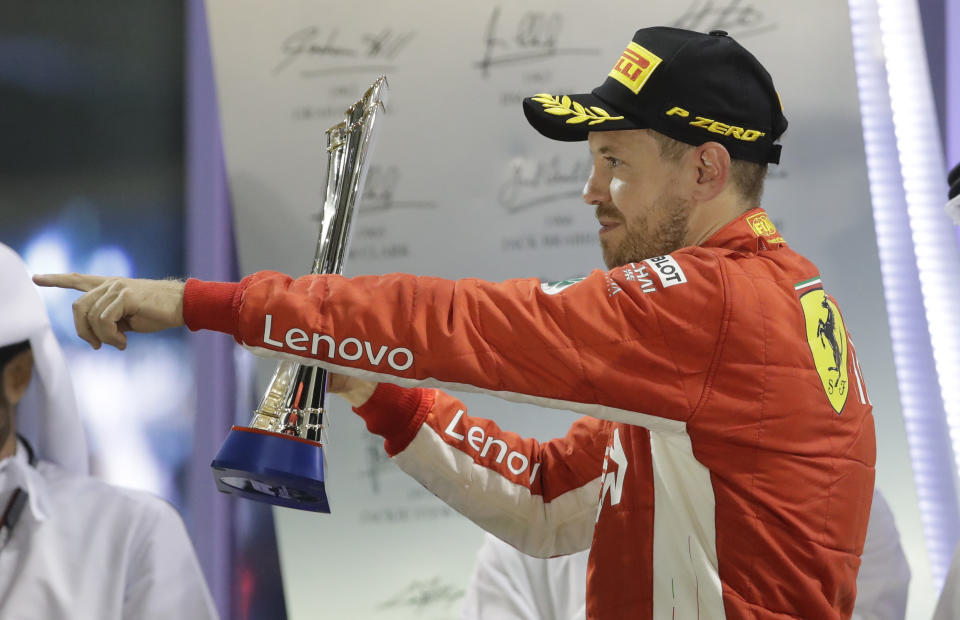 Ferrari driver Sebastian Vettel of Germany celebrates his second place on the podium after the Emirates Formula One Grand Prix at the Yas Marina racetrack in Abu Dhabi, United Arab Emirates, Sunday, Nov. 25, 2018.(AP Photo/Luca Bruno)