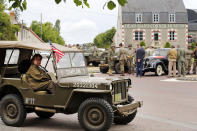 <p>Men dressed with U.S. military uniforms attend commemorations marking the 73th anniversary of D-Day in Hiesville, France, on Tuesday. (Photo: Chesnot/Getty Images) </p>